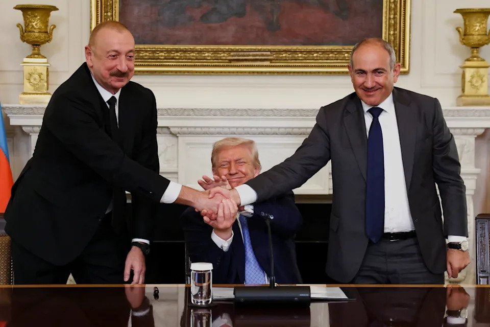 U.S. President Donald Trump holds the hands of Azerbaijan's President Ilham Aliyev and Armenia's Prime Minister Nikol Pashinyan as they shake hands between each other during a trilateral signing event, at the White House, in Washington, D.C., August 8, 2025.